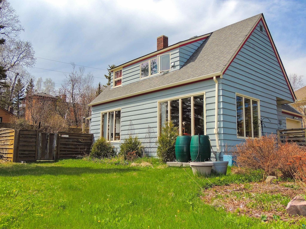 103 3rd Ave W, Grand Marais, MN 55604 - rear view of property featuring a chimney and roof with shingles