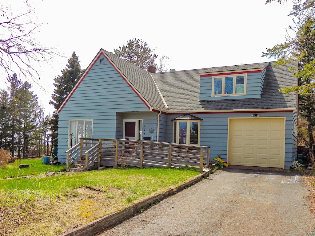103 3rd Ave W, Grand Marais, MN 55604 - view of front of home featuring driveway, a garage, a deck, and a shingled roof