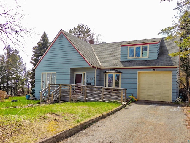 103 3rd Ave W, Grand Marais, MN 55604 - view of front of home featuring driveway, a garage, a deck, and a shingled roof