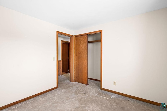3026 Getchell Rd, Duluth, MN 55810 - unfurnished bedroom with baseboards, a closet, and concrete flooring