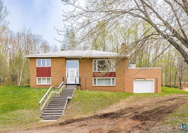 3026 Getchell Rd, Duluth, MN 55810 - split foyer home featuring a chimney, a garage, a front lawn, dirt driveway, and brick siding