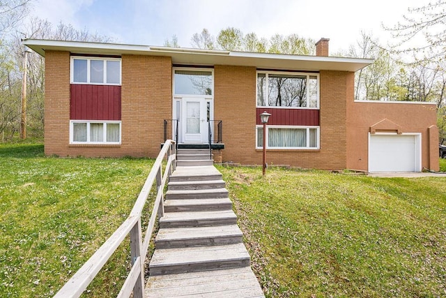 3026 Getchell Rd, Duluth, MN 55810 - raised ranch with a chimney, brick siding, a front yard, and an attached garage