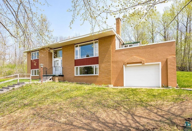 3026 Getchell Rd, Duluth, MN 55810 - split foyer home with a chimney, a front yard, brick siding, and a garage