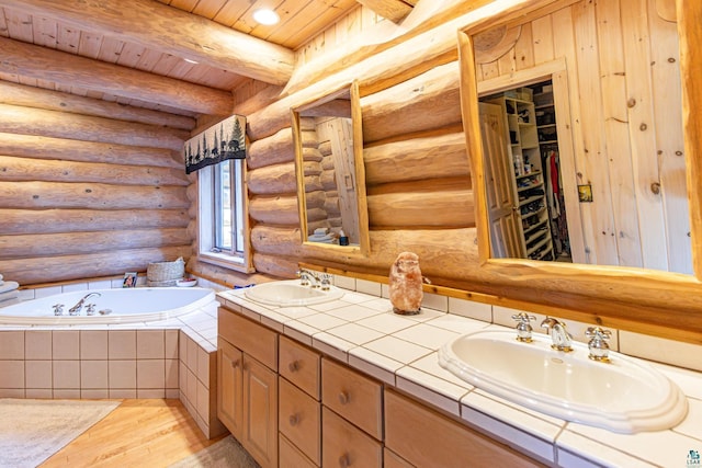 693 Kawishiwi Trl, Ely, MN 55731 - bathroom featuring wood finished floors, wood ceiling, double vanity, log walls, and a garden tub