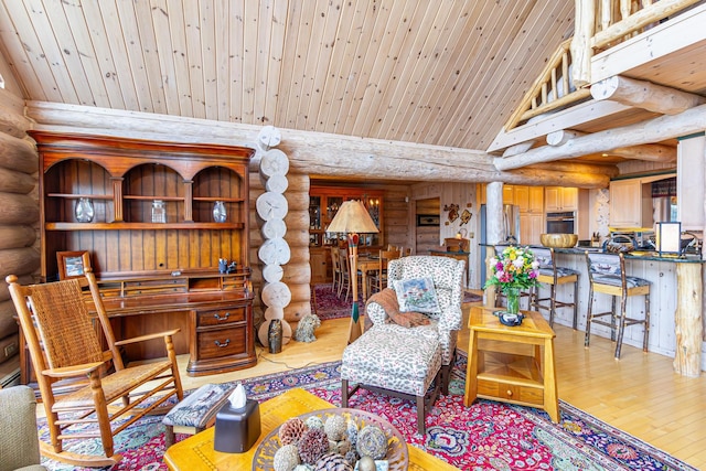 693 Kawishiwi Trl, Ely, MN 55731 - living room featuring log walls, wood-type flooring, wood ceiling, and vaulted ceiling