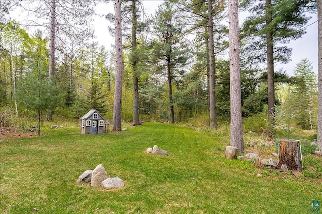 25 Maki Rd, Esko, MN 55733 - view of grassy yard with a storage unit and an outdoor structure