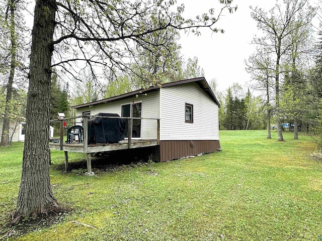 1529 Riddell Rd, Cook, MN 55723 - view of side of property featuring a deck and a lawn