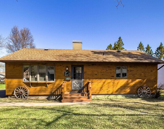 110 Hays Crk, Silver Bay, MN 55614 - view of front facade featuring a front lawn, a chimney, and a shingled roof