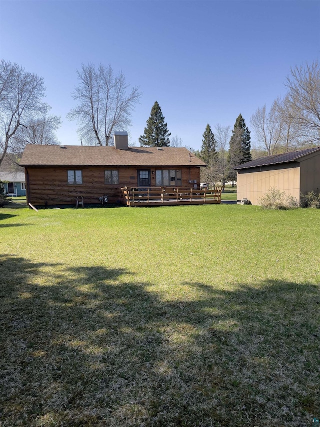 110 Hays Crk, Silver Bay, MN 55614 - back of house with a wooden deck and a lawn