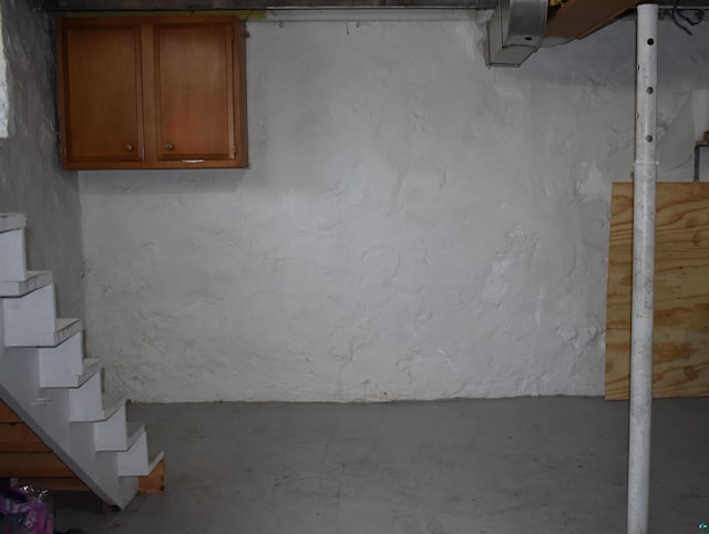 unfinished below grade area featuring stairs
