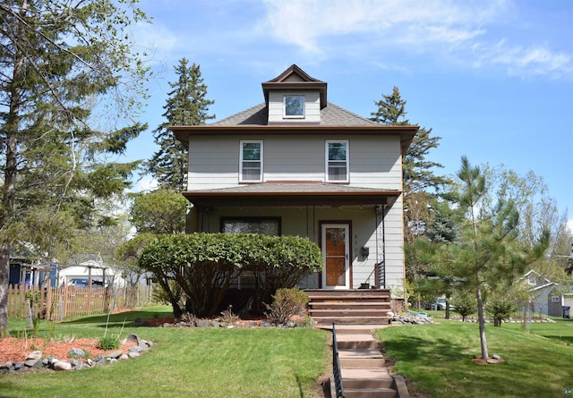traditional style home featuring covered porch and a shingled roof