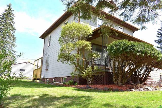 view of side of property with a yard