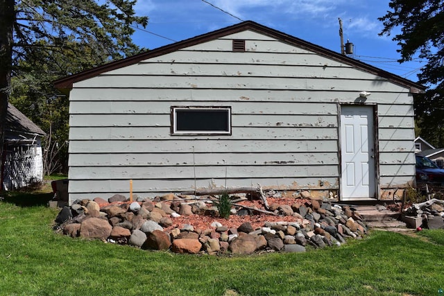 view of property exterior with a lawn