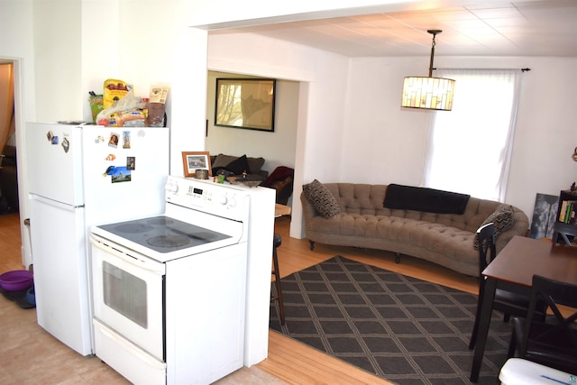 kitchen with white appliances and light wood-style flooring