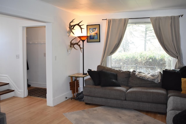 living area featuring wood finished floors and stairs