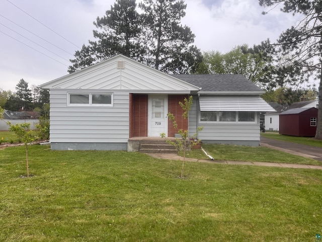 709 Birch Ave, Moose Lake, MN 55767 - bungalow with a front lawn and roof with shingles