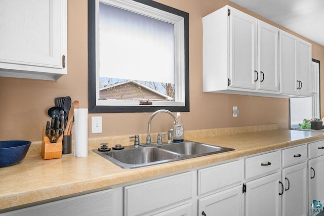 733 13th Ave, Two Harbors, MN 55616 - kitchen featuring a sink, white cabinetry, and light countertops