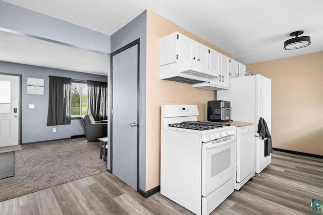733 13th Ave, Two Harbors, MN 55616 - kitchen with white appliances, under cabinet range hood, wood finished floors, white cabinetry, and baseboards