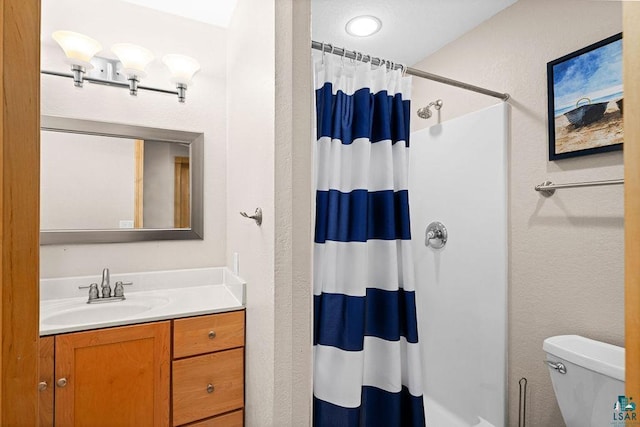203 S 2nd Ave, Proctor, MN 55810 - bathroom with a shower with shower curtain, a textured wall, toilet, and vanity