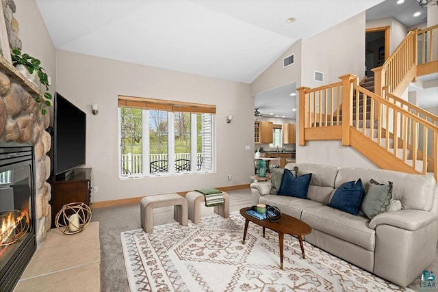 203 S 2nd Ave, Proctor, MN 55810 - living room with lofted ceiling, baseboards, a fireplace, stairs, and carpet