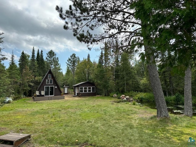 1473 S Kane Lake Rd, Two Harbors, MN 55616 - view of green lawn with a view of trees