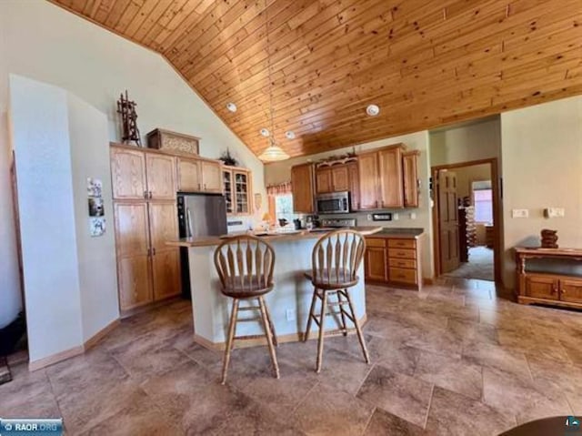 3622 Wildgate Rd, Ely, MN 55731 - kitchen featuring appliances with stainless steel finishes, wood ceiling, a center island, a breakfast bar area, and high vaulted ceiling
