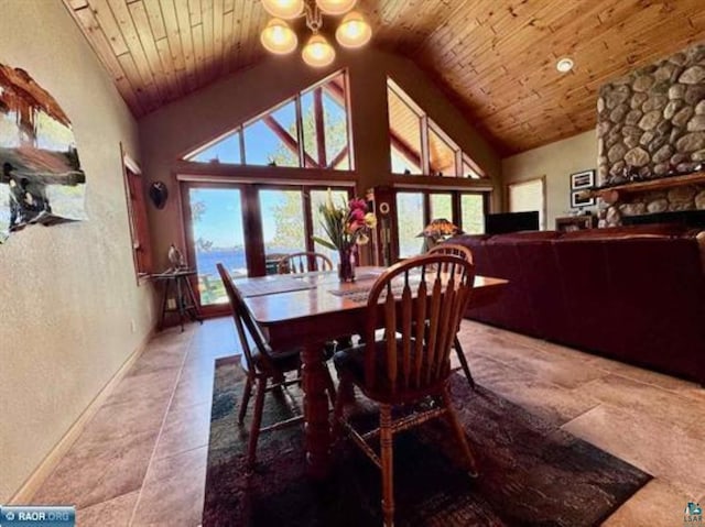 3622 Wildgate Rd, Ely, MN 55731 - tiled dining space featuring baseboards, high vaulted ceiling, wooden ceiling, a chandelier, and a fireplace