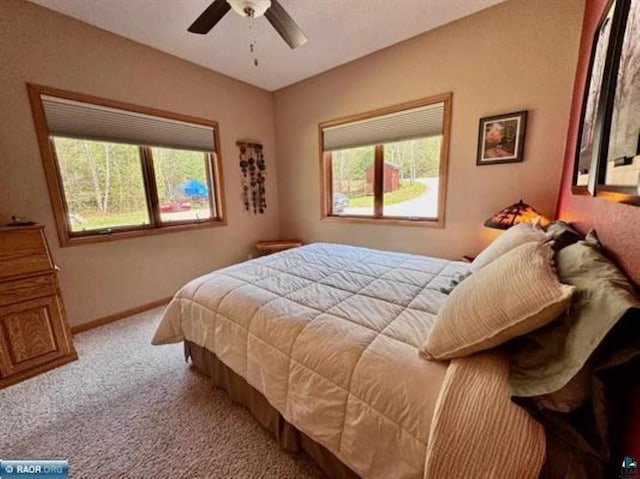 3622 Wildgate Rd, Ely, MN 55731 - carpeted bedroom featuring multiple windows, baseboards, and ceiling fan