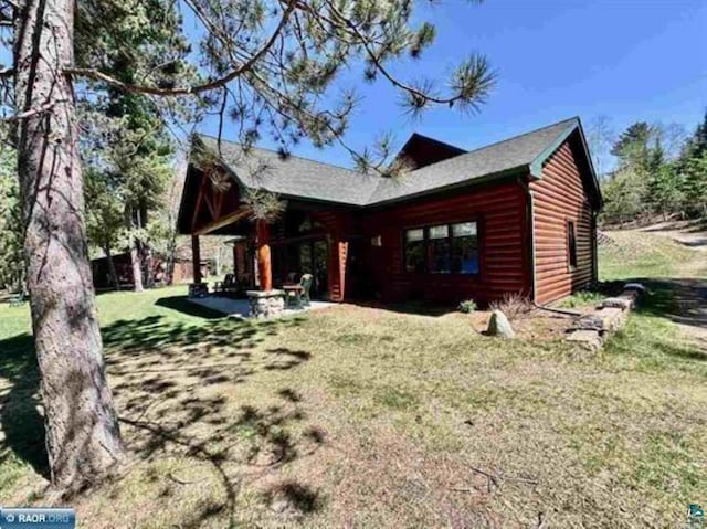 3622 Wildgate Rd, Ely, MN 55731 - back of property featuring faux log siding, a yard, and a patio area