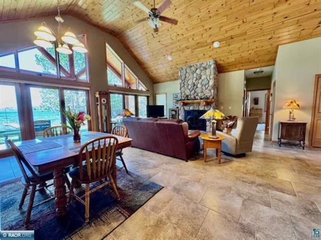 3622 Wildgate Rd, Ely, MN 55731 - dining room featuring a chandelier, plenty of natural light, a stone fireplace, high vaulted ceiling, and ceiling fan