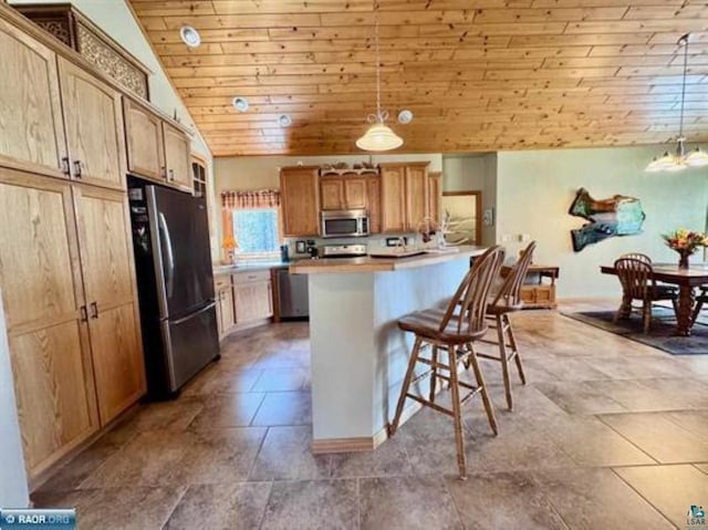 3622 Wildgate Rd, Ely, MN 55731 - kitchen with appliances with stainless steel finishes, vaulted ceiling, wooden ceiling, a kitchen bar, and a peninsula