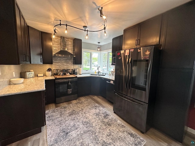 706 28th St, Cloquet, MN 55720 - kitchen featuring range with electric stovetop, wall chimney exhaust hood, light wood finished floors, and backsplash