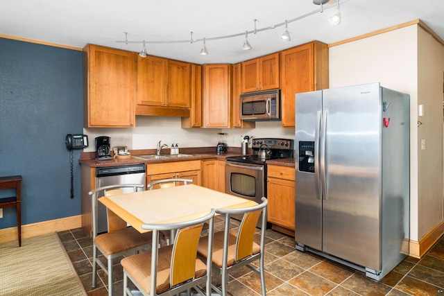 21 E Wisconsin St Unit 301, Grand Marais, MN 55616 - kitchen with stainless steel appliances, a sink, dark countertops, and baseboards