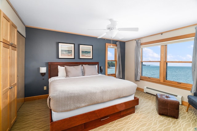 21 E Wisconsin St Unit 301, Grand Marais, MN 55616 - bedroom with baseboard heating, baseboards, a water view, a closet, and ornamental molding