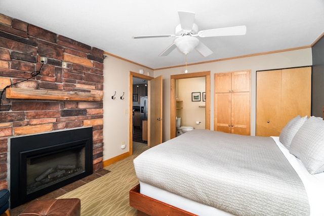 21 E Wisconsin St Unit 301, Grand Marais, MN 55616 - carpeted bedroom with ornamental molding, a fireplace, ensuite bathroom, baseboards, and a ceiling fan