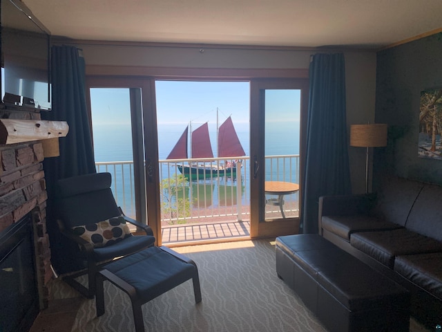 21 E Wisconsin St Unit 301, Grand Marais, MN 55616 - living area with a water view and a stone fireplace