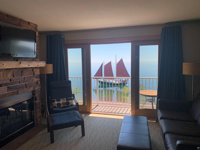 21 E Wisconsin St Unit 301, Grand Marais, MN 55616 - living room with a water view and a stone fireplace