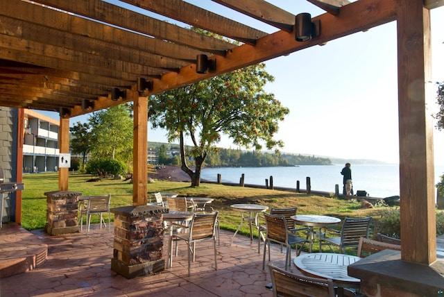 21 E Wisconsin St Unit 301, Grand Marais, MN 55616 - view of patio featuring outdoor dining space, a water view, and a pergola