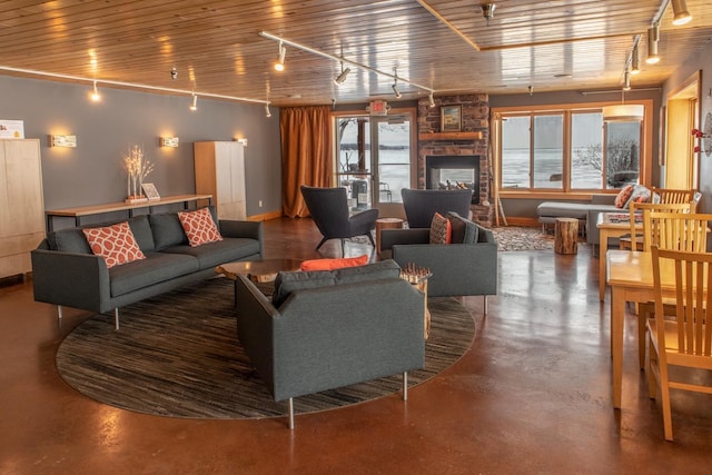 21 E Wisconsin St Unit 301, Grand Marais, MN 55616 - living room with rail lighting, concrete flooring, healthy amount of natural light, baseboards, and wood ceiling