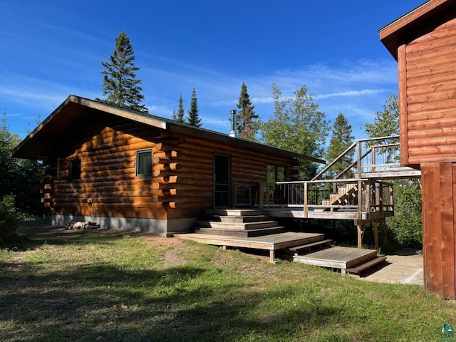 109 Tom Overlook Trl, Hovland, MN 55606 - view of side of home featuring log siding, stairs, a yard, and a wooden deck