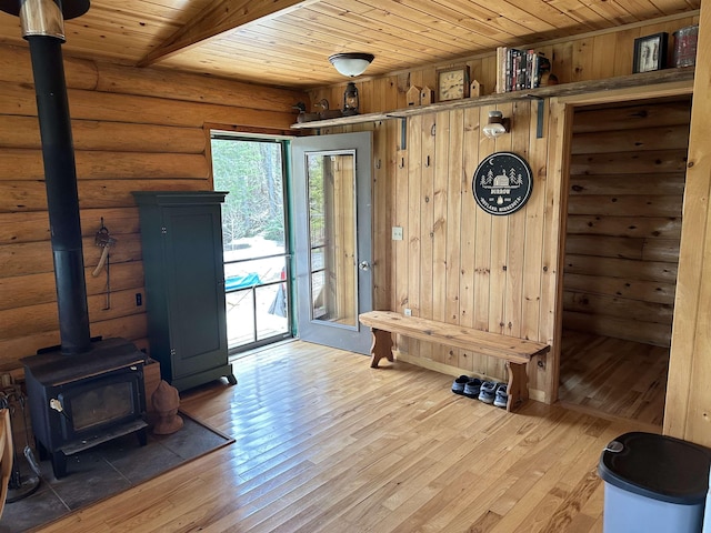 109 Tom Overlook Trl, Hovland, MN 55606 - mudroom with wooden ceiling, a wood stove, hardwood / wood-style flooring, log walls, and wood walls