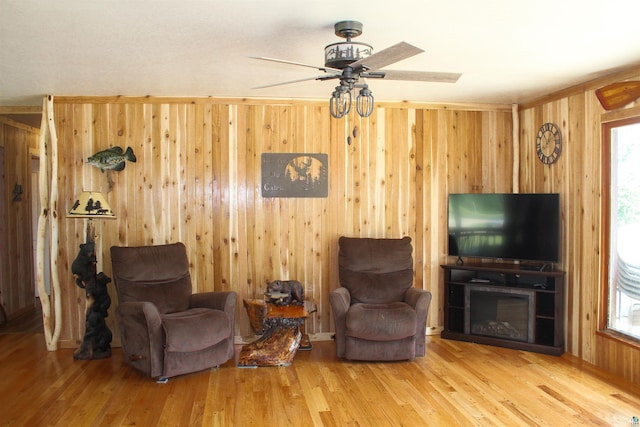 444 Fernberg Rd Unit 11, Ely, MN 55731 - sitting room with wooden walls, wood finished floors, and a ceiling fan