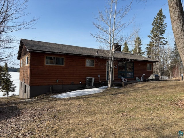 444 Fernberg Rd Unit 11, Ely, MN 55731 - rear view of house with cooling unit, a lawn, a chimney, roof with shingles, and a patio