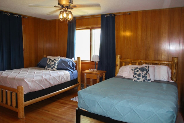 444 Fernberg Rd Unit 11, Ely, MN 55731 - bedroom with wood finished floors, wooden walls, and a ceiling fan