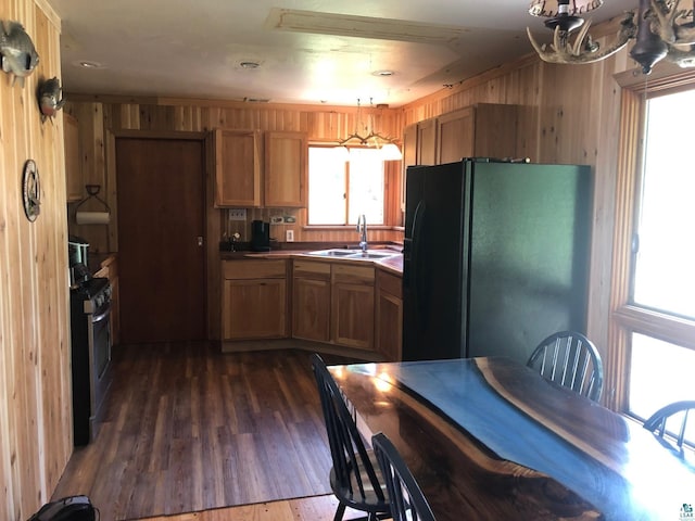 444 Fernberg Rd Unit 11, Ely, MN 55731 - kitchen featuring a sink, freestanding refrigerator, stainless steel gas stove, wood walls, and dark wood-style flooring