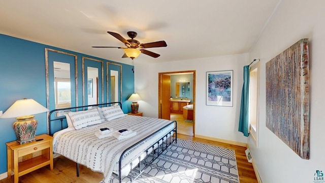 296 Cramer Rd, Schroeder, MN 55613 - bedroom featuring wood finished floors, baseboards, ensuite bath, and a ceiling fan