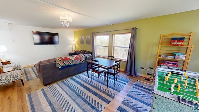 296 Cramer Rd, Schroeder, MN 55613 - living area with wood finished floors, baseboards, and a chandelier