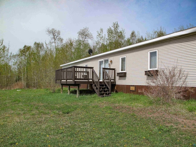296 Cramer Rd, Schroeder, MN 55613 - rear view of house featuring a deck, a lawn, and crawl space