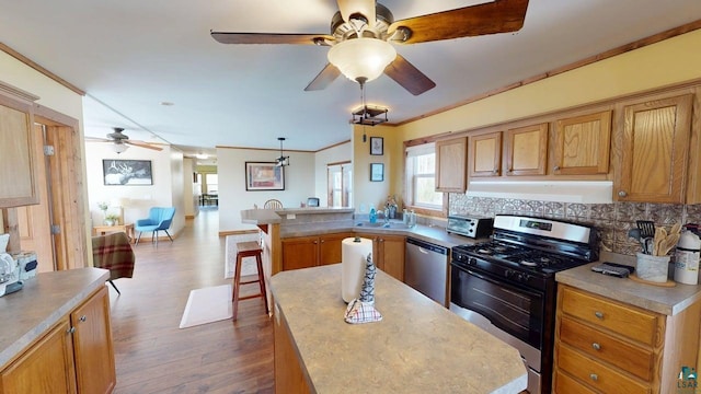 296 Cramer Rd, Schroeder, MN 55613 - kitchen featuring appliances with stainless steel finishes, extractor fan, ceiling fan, a peninsula, and dark wood-style floors