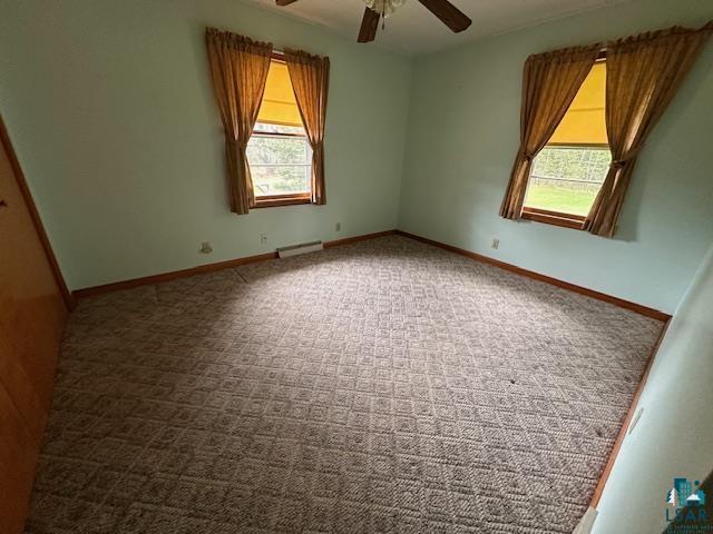 5960 Evergreen Rd, Aurora, MN 55705 - carpeted spare room with a ceiling fan, healthy amount of natural light, and baseboards